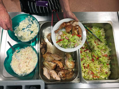 Picture of food being served in the community kitchen